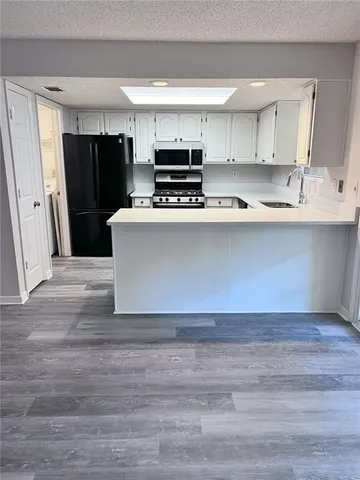 a kitchen with a refrigerator and a sink