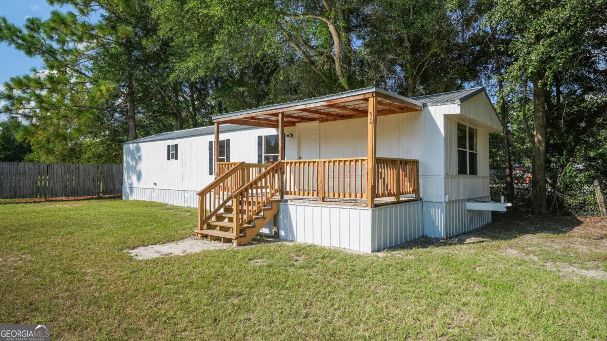50 Sangster Road Jesup, GA 31545 - Photo 1 of 22 a view of a house with backyard and sitting area