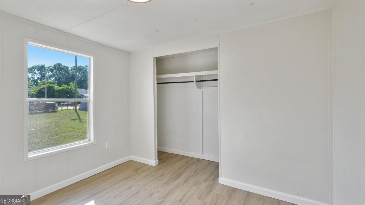 50 Sangster Road Jesup, GA 31545 - Photo 14 of 22 a view of an empty room with wooden floor and a window