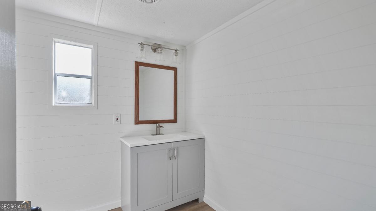 50 Sangster Road Jesup, GA 31545 - Photo 17 of 22 a bathroom with a sink a mirror and vanity