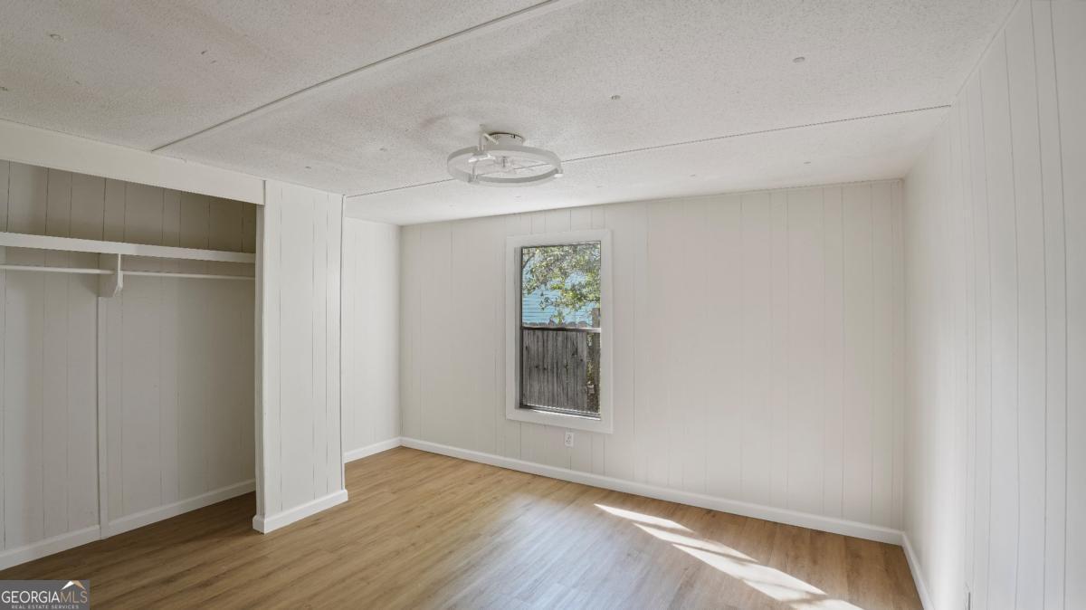 50 Sangster Road Jesup, GA 31545 - Photo 19 of 22 a view of an empty room with wooden floor and a window