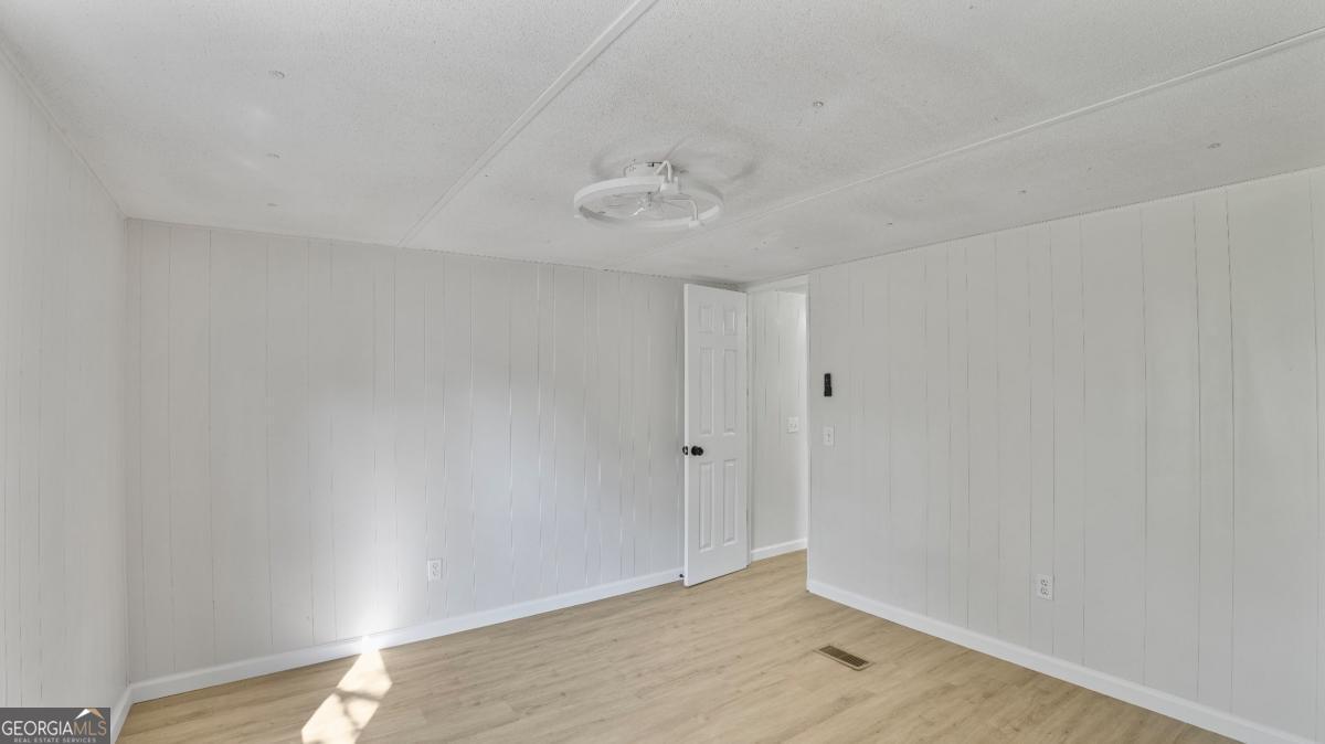 50 Sangster Road Jesup, GA 31545 - Photo 20 of 22 a view of an empty room with wooden floor