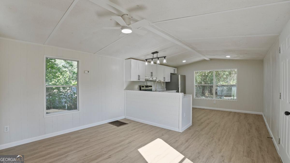 50 Sangster Road Jesup, GA 31545 - Photo 3 of 22 wooden floor in an empty room with a window