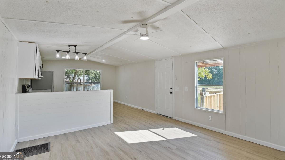 50 Sangster Road Jesup, GA 31545 - Photo 4 of 22 a living room with hard wood floors and a ceiling fan