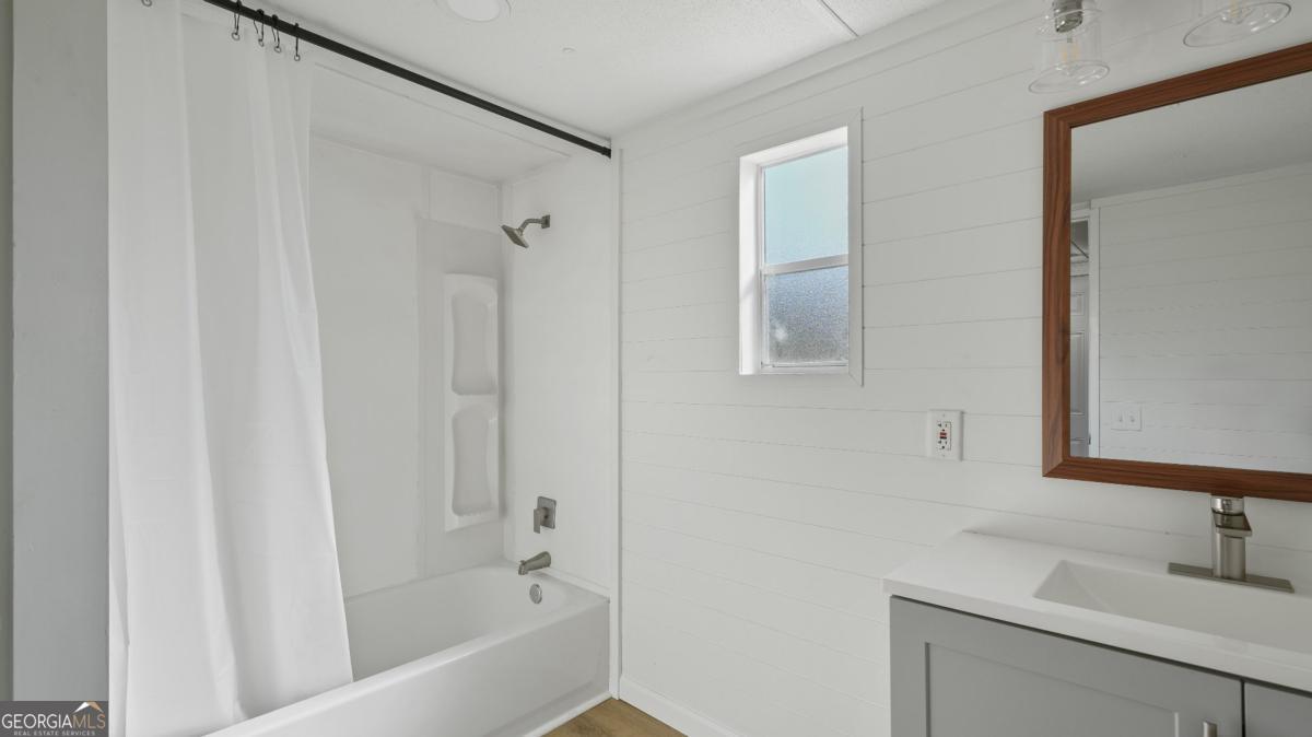 50 Sangster Road Jesup, GA 31545 - Photo 5 of 22 a bathroom with a bathtub and a sink