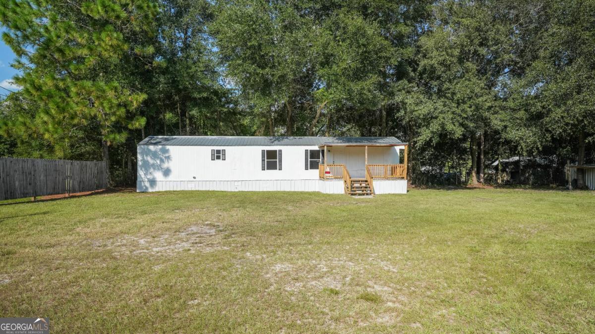 50 Sangster Road Jesup, GA 31545 - Photo 7 of 22 a view of a house with a backyard