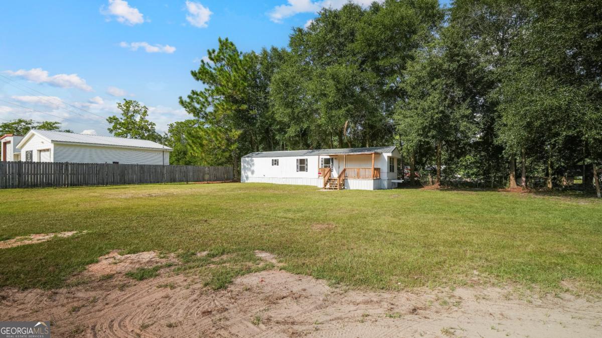 50 Sangster Road Jesup, GA 31545 - Photo 8 of 22 a front view of a house with garden