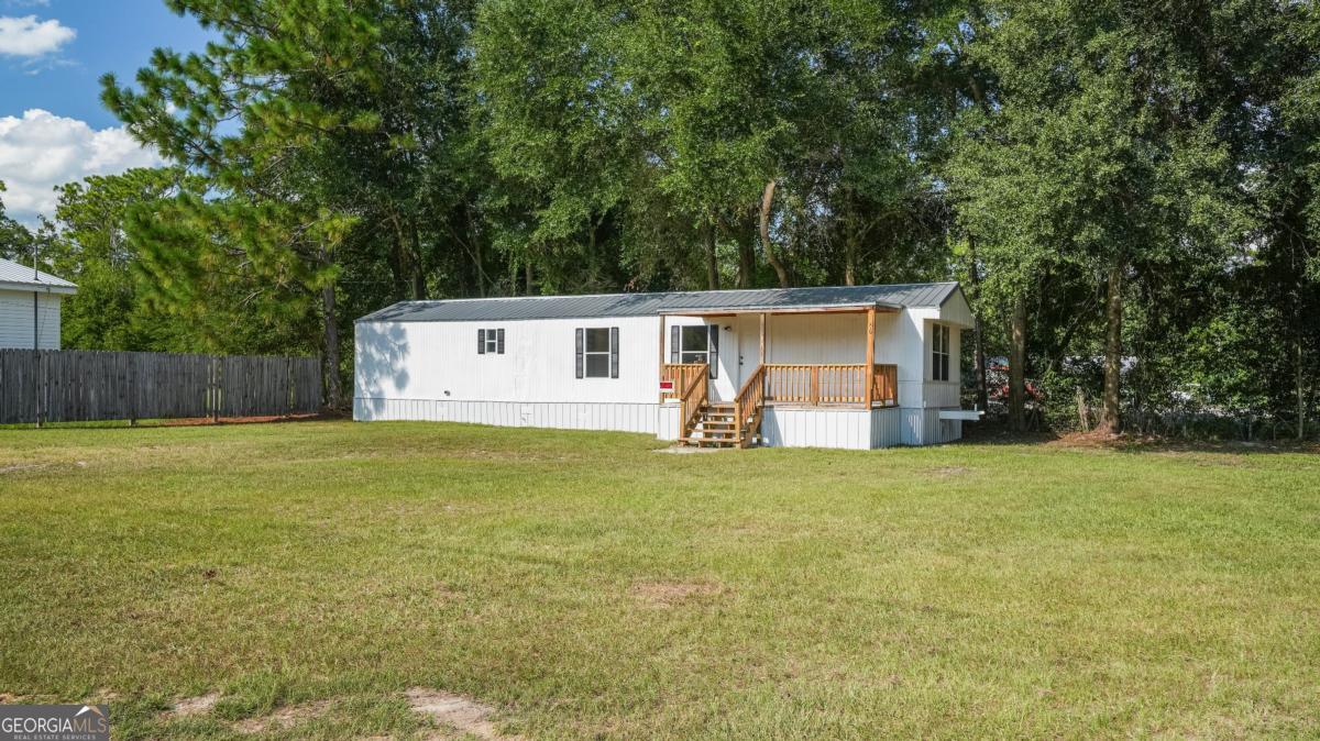 50 Sangster Road Jesup, GA 31545 - Photo 9 of 22 a view of a house with backyard and trees