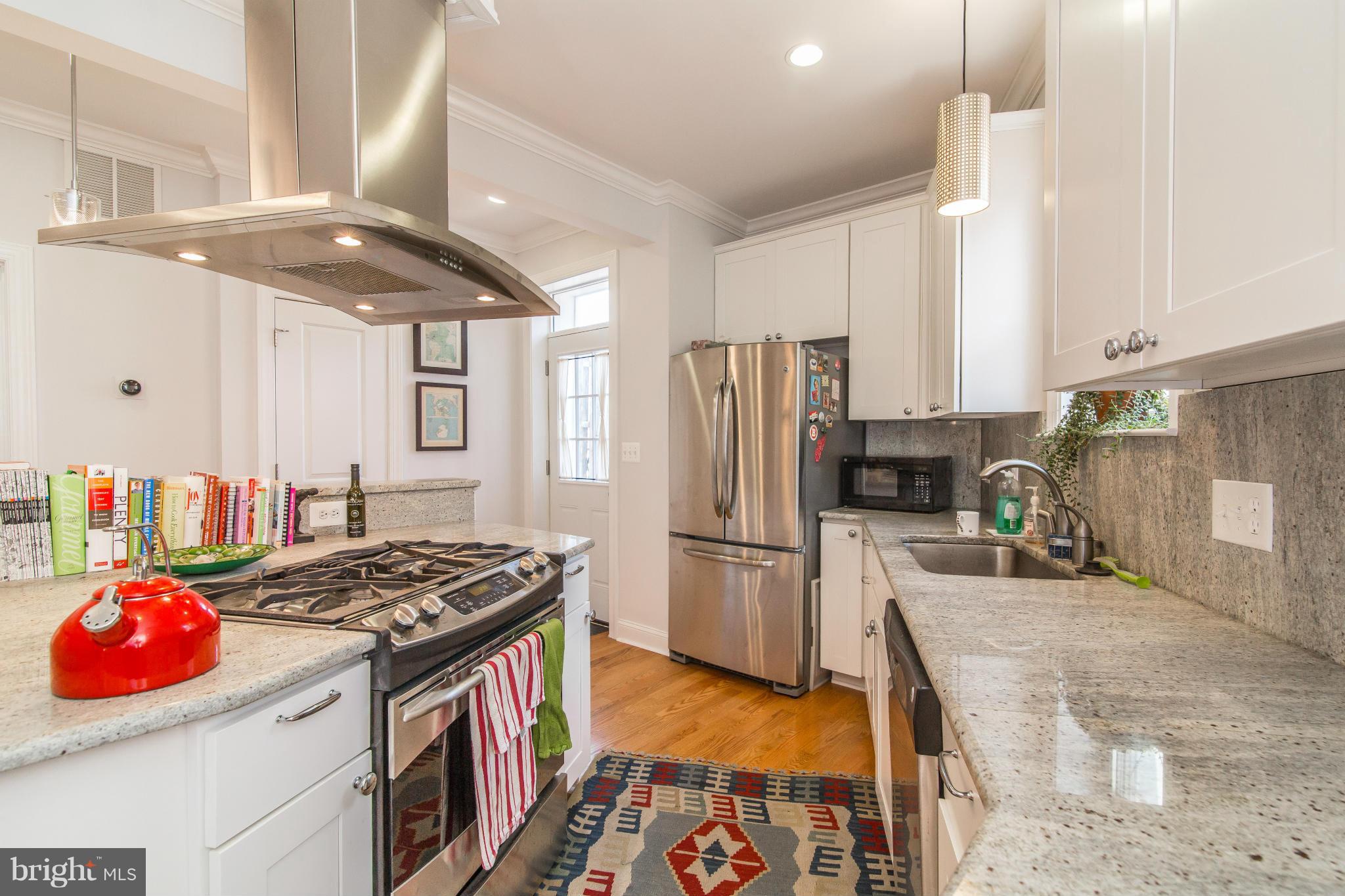 1849 3rd Street Northwest Washington, DC 20001 - Photo 8 of 23 a kitchen with stainless steel appliances granite countertop a stove a sink and a refrigerator