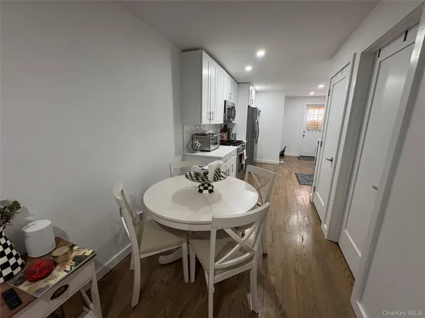 a kitchen with stainless steel appliances granite countertop a refrigerator stove and white cabinets