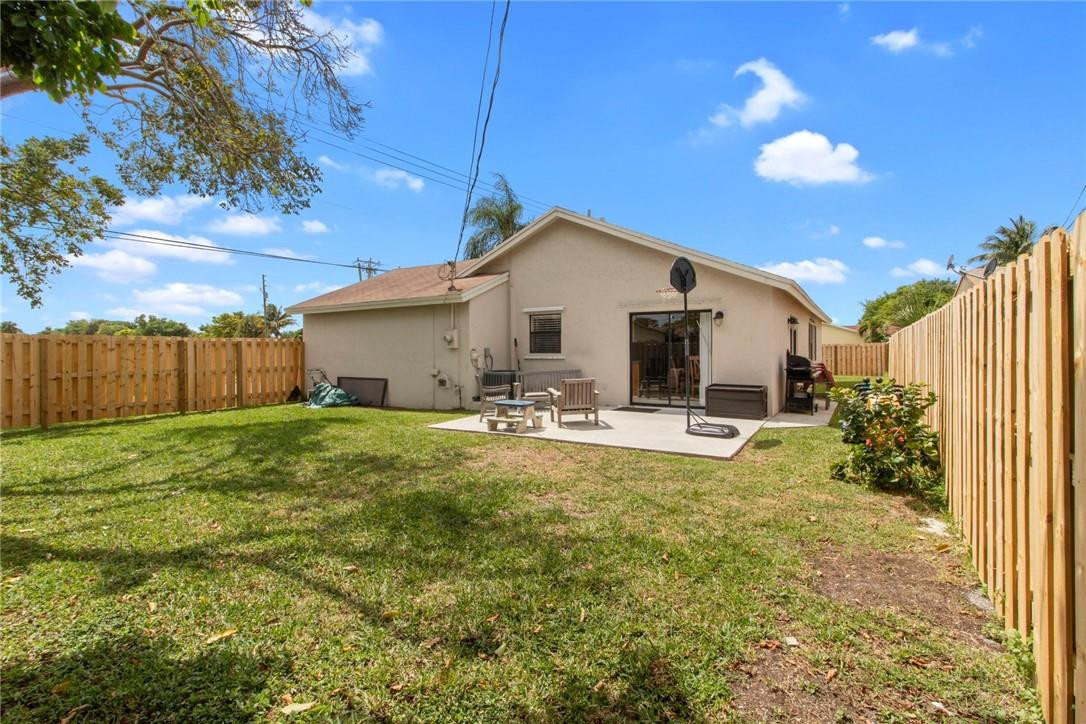 22244 Southwest 64th Terrace Boca Raton, FL 33428 - Photo 22 of 25 a view of a house with backyard and sitting area