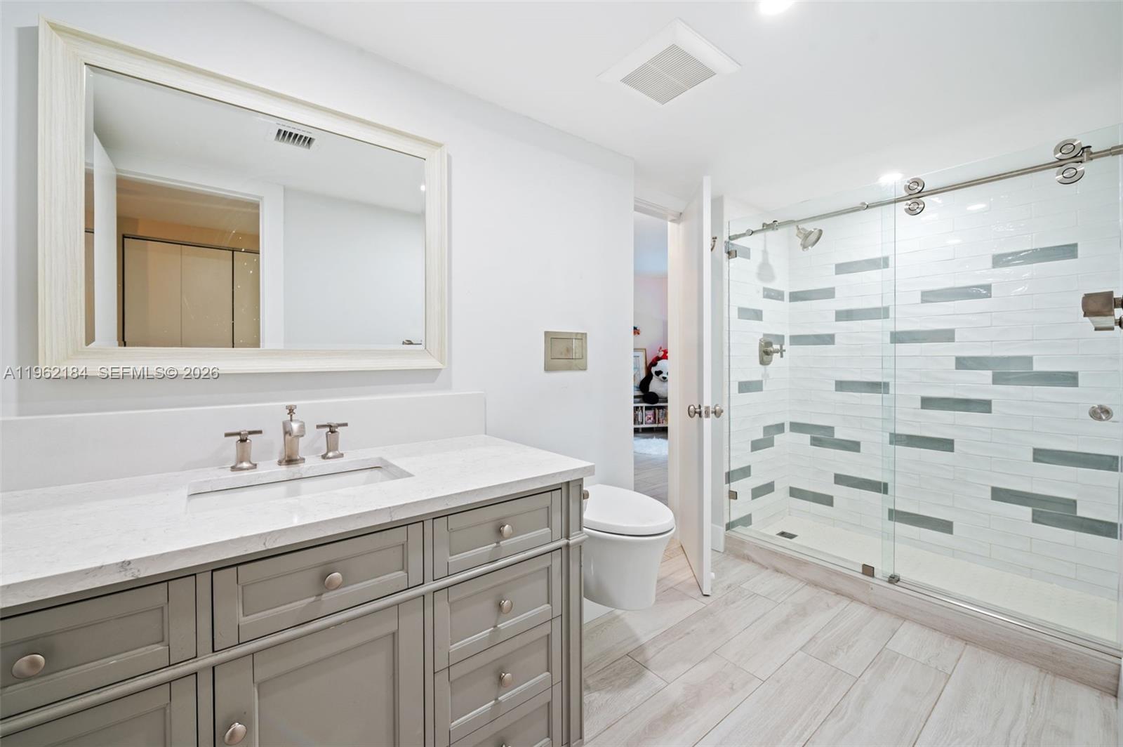 600 Grapetree Drive, Unit 3DS Key Biscayne, FL 33149 - Photo 16 of 33 a bathroom with a sink a toilet and shower