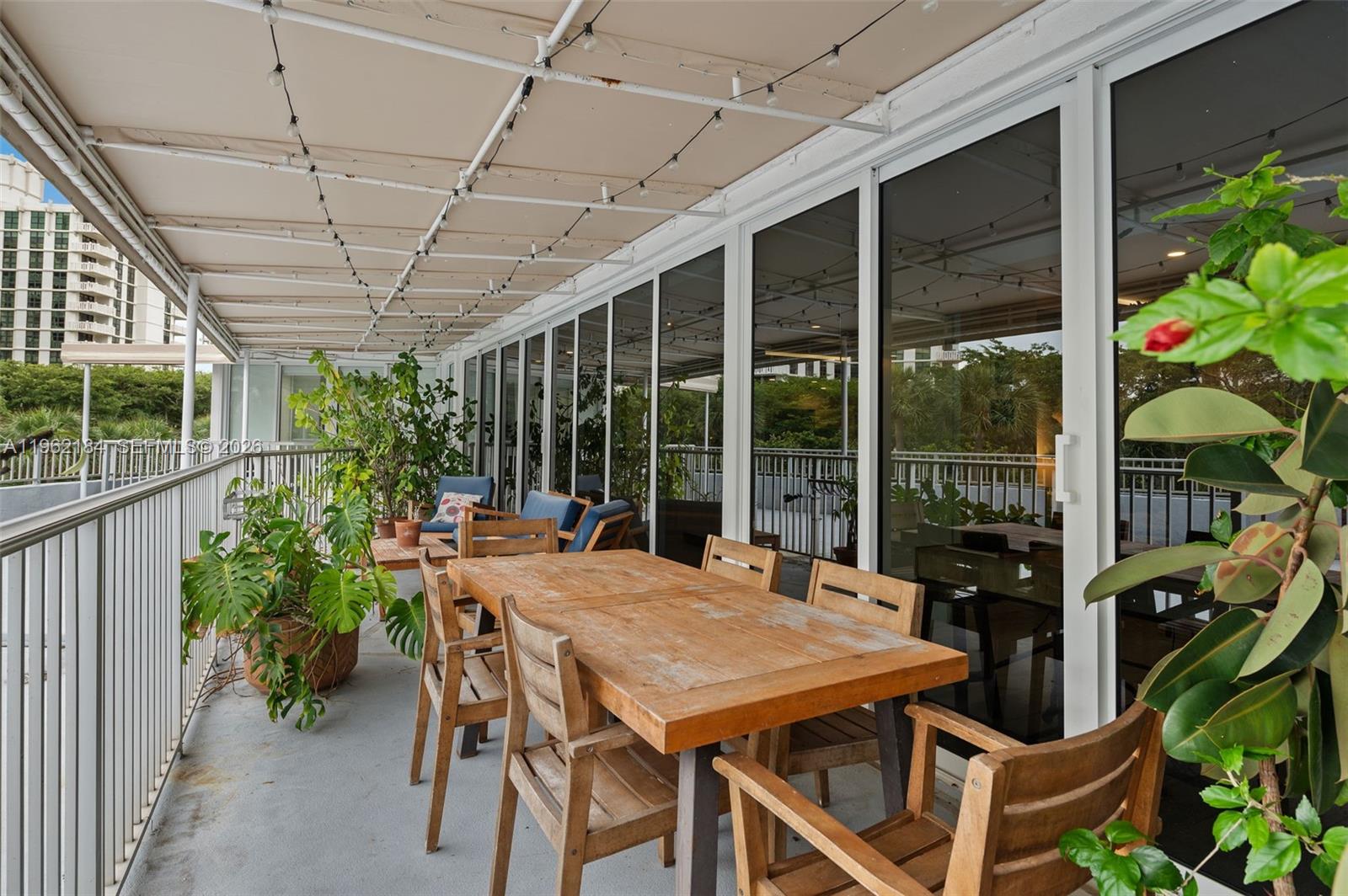 600 Grapetree Drive, Unit 3DS Key Biscayne, FL 33149 - Photo 19 of 33 a view of a patio with a table and chairs next to a yard