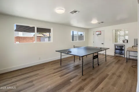 a view of a workspace with furniture window and wooden floor
