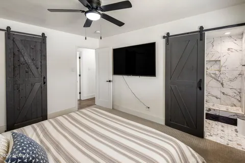 a bedroom with a bed and a flat screen tv