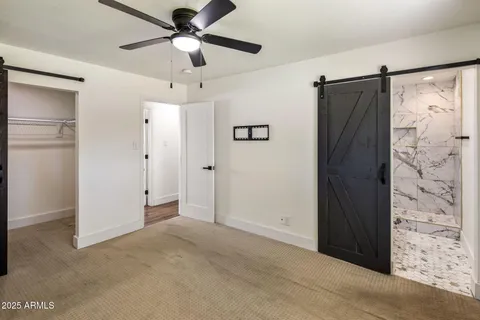 a view of an empty room with a ceiling fan