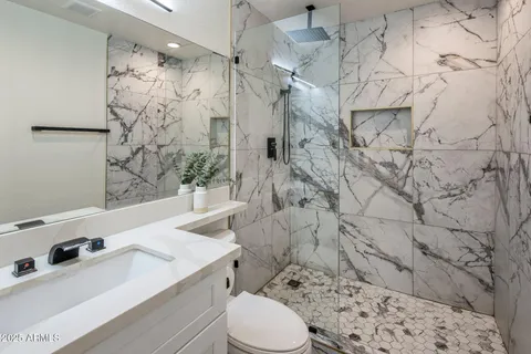 a bathroom with a sink toilet and shower