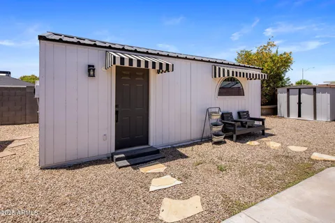 a view of backyard with a patio and a tub