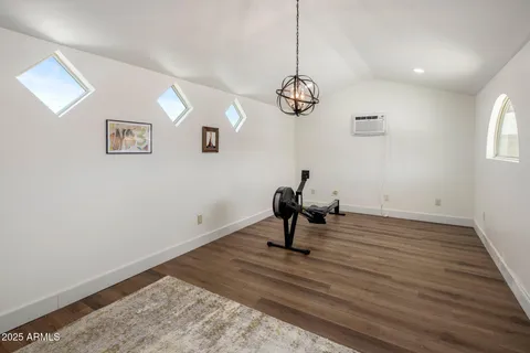 a view of empty room with a sink and chandelier fan