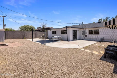 a backyard of a house with barbeque oven and outdoor seating