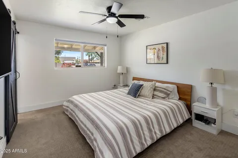 a bedroom with bed and painting on the wall