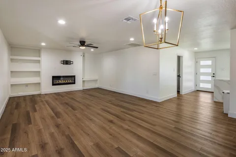 wooden floor in an empty room with a mirror