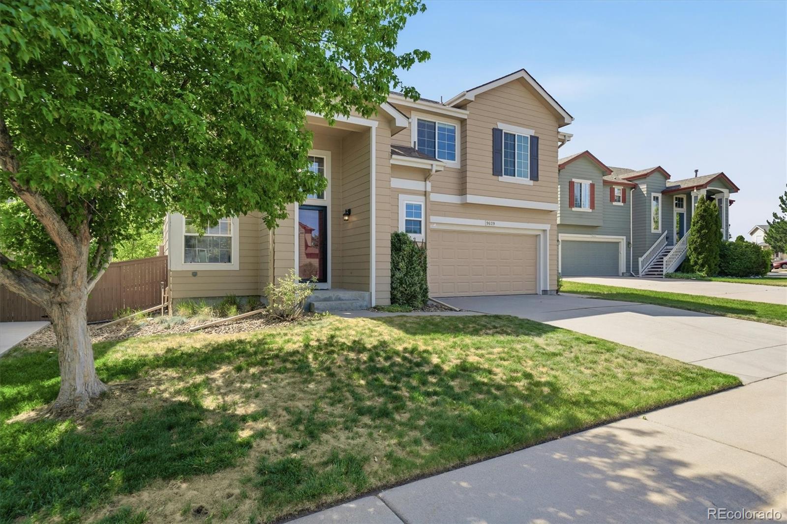 9629 Burberry Way Highlands Ranch, CO 80129 - Photo 3 of 50 a front view of a house with a yard