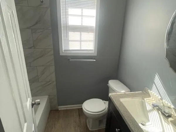 a white toilet sitting next to a window
