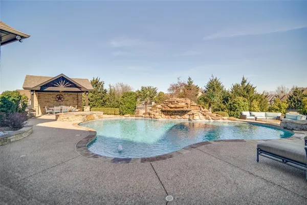 an aerial view of a house with outdoor space lake view and a yard