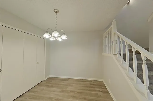 a view of a chandelier fan and wooden floor