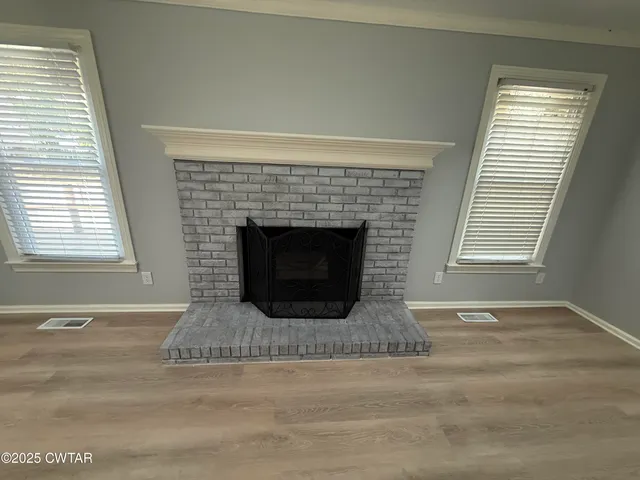 a living room with a fireplace and a fireplace