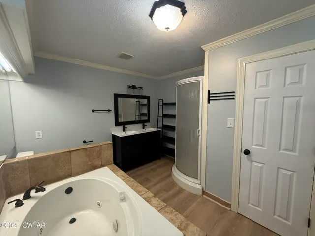 a bathroom with a tub sink and mirror