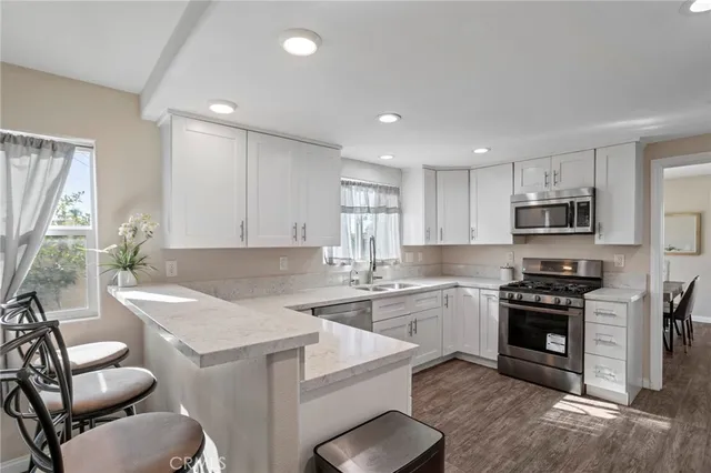 a kitchen with a sink stove top oven and refrigerator