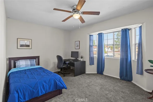 a bedroom with a bed and a large window