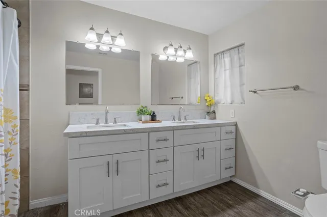 a bathroom with a double vanity sink and a mirror