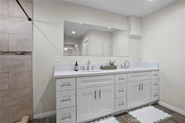 a bathroom with a double vanity sink and a mirror