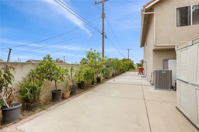 a view of a street with potted plants
