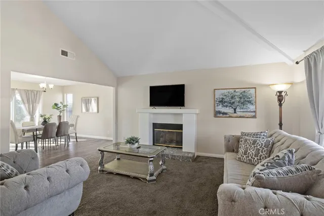a living room with furniture and a fireplace
