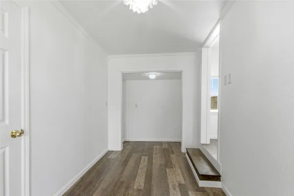 a view of a room with wooden floor and small space