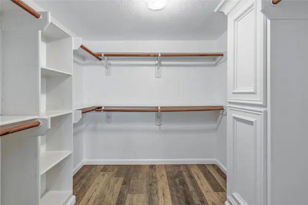 a view of walk in closet with empty racks