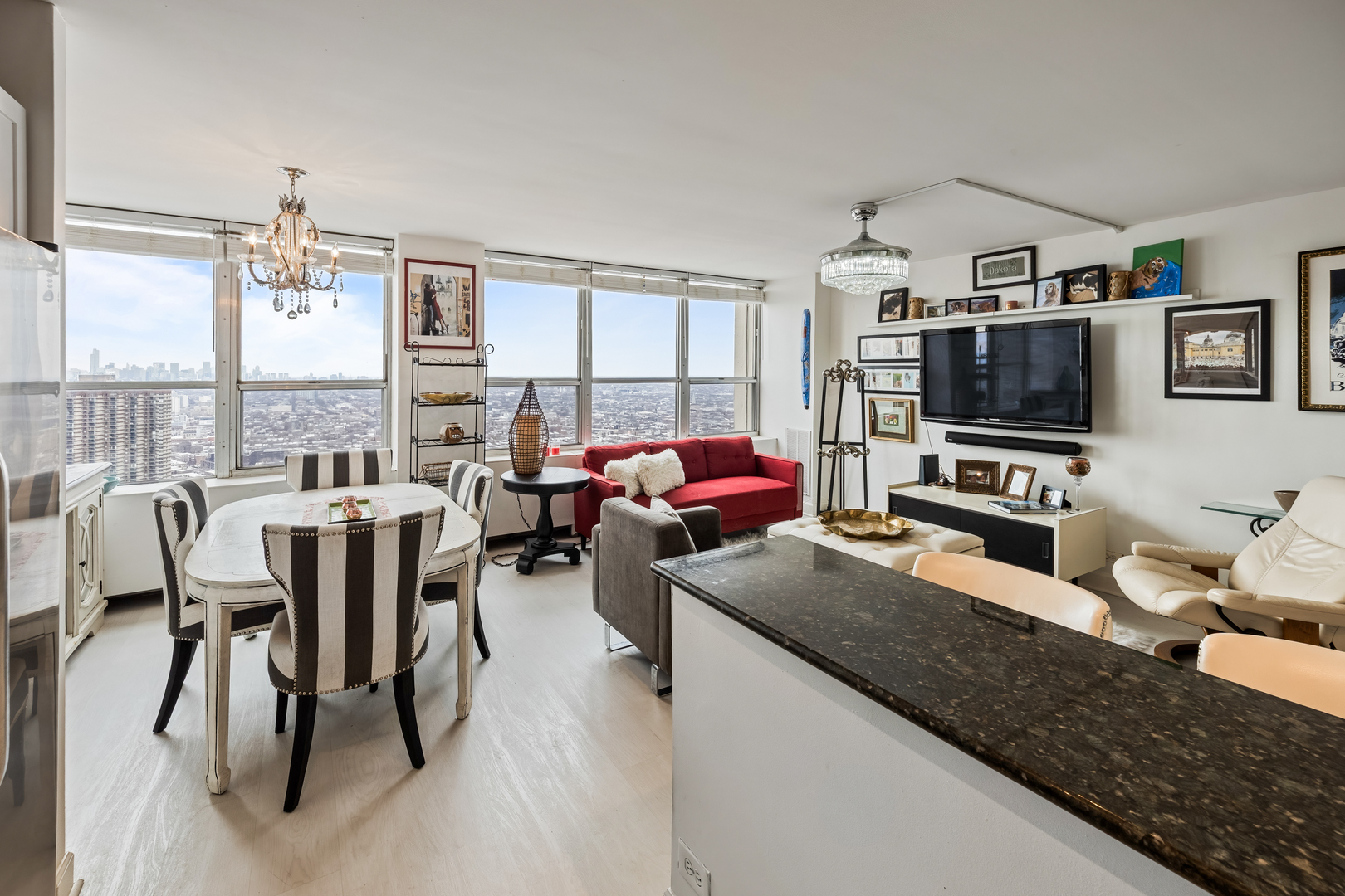 655 West Irving Park Road, Unit 5315 Chicago, IL 60613 - Photo 11 of 29 a living room with furniture a flat screen tv and a dining table
