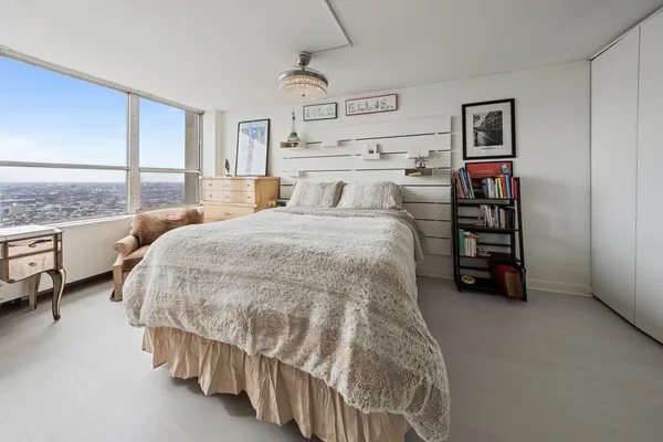 a spacious bedroom with a bed and a walk in closet