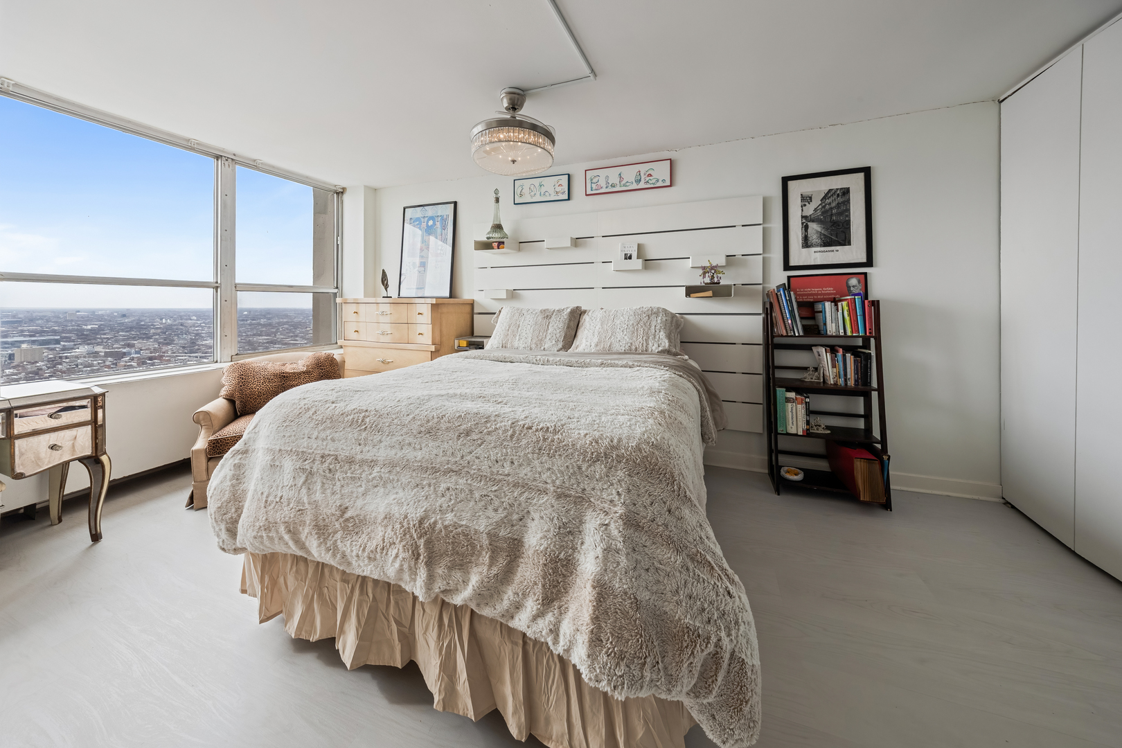 655 West Irving Park Road, Unit 5315 Chicago, IL 60613 - Photo 17 of 29 a spacious bedroom with a bed and a walk in closet