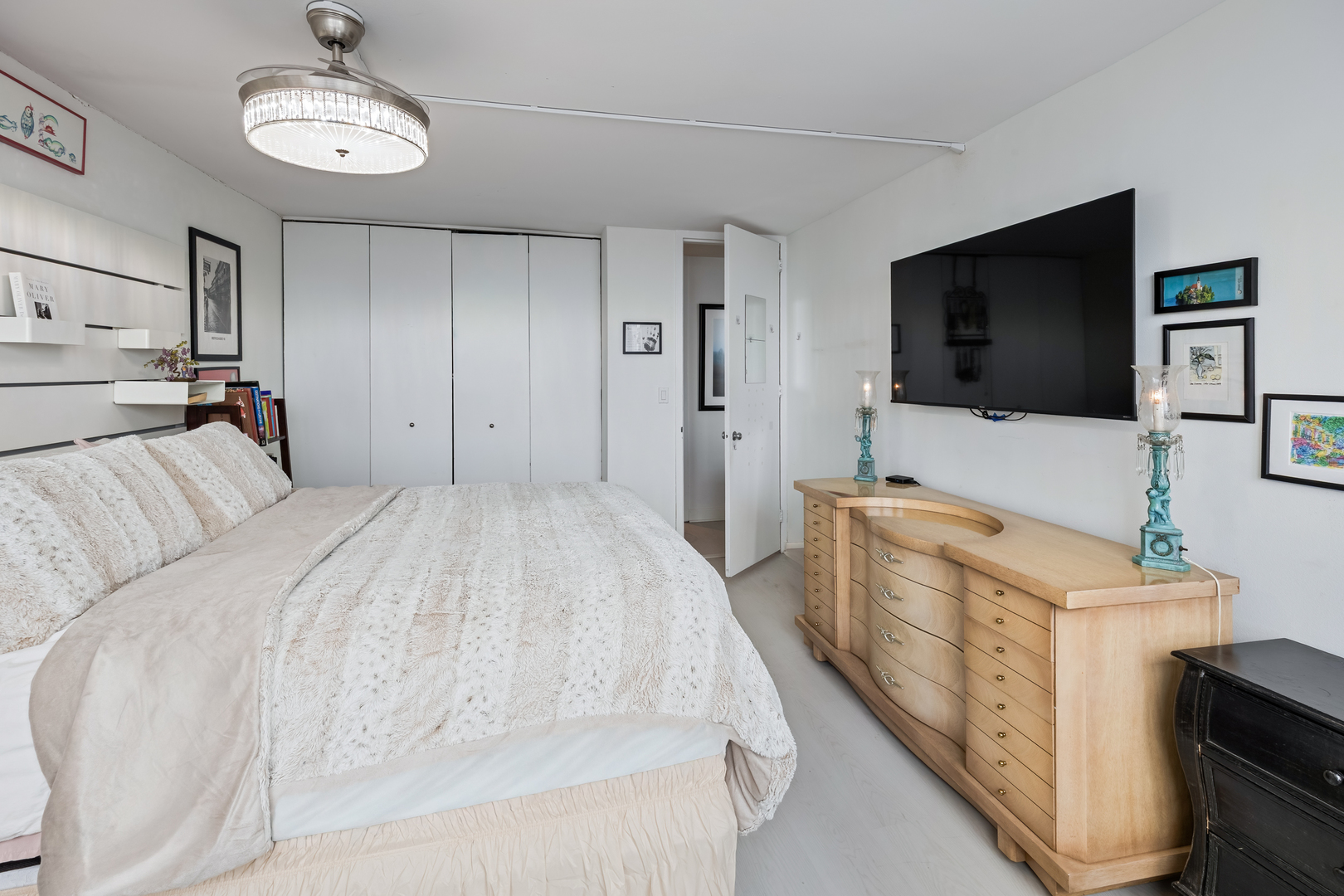 655 West Irving Park Road, Unit 5315 Chicago, IL 60613 - Photo 18 of 29 a spacious bedroom with a bed and a flat screen tv