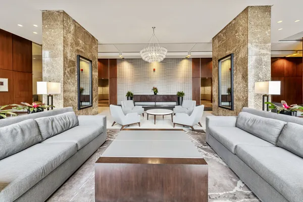 a living room with furniture and a chandelier