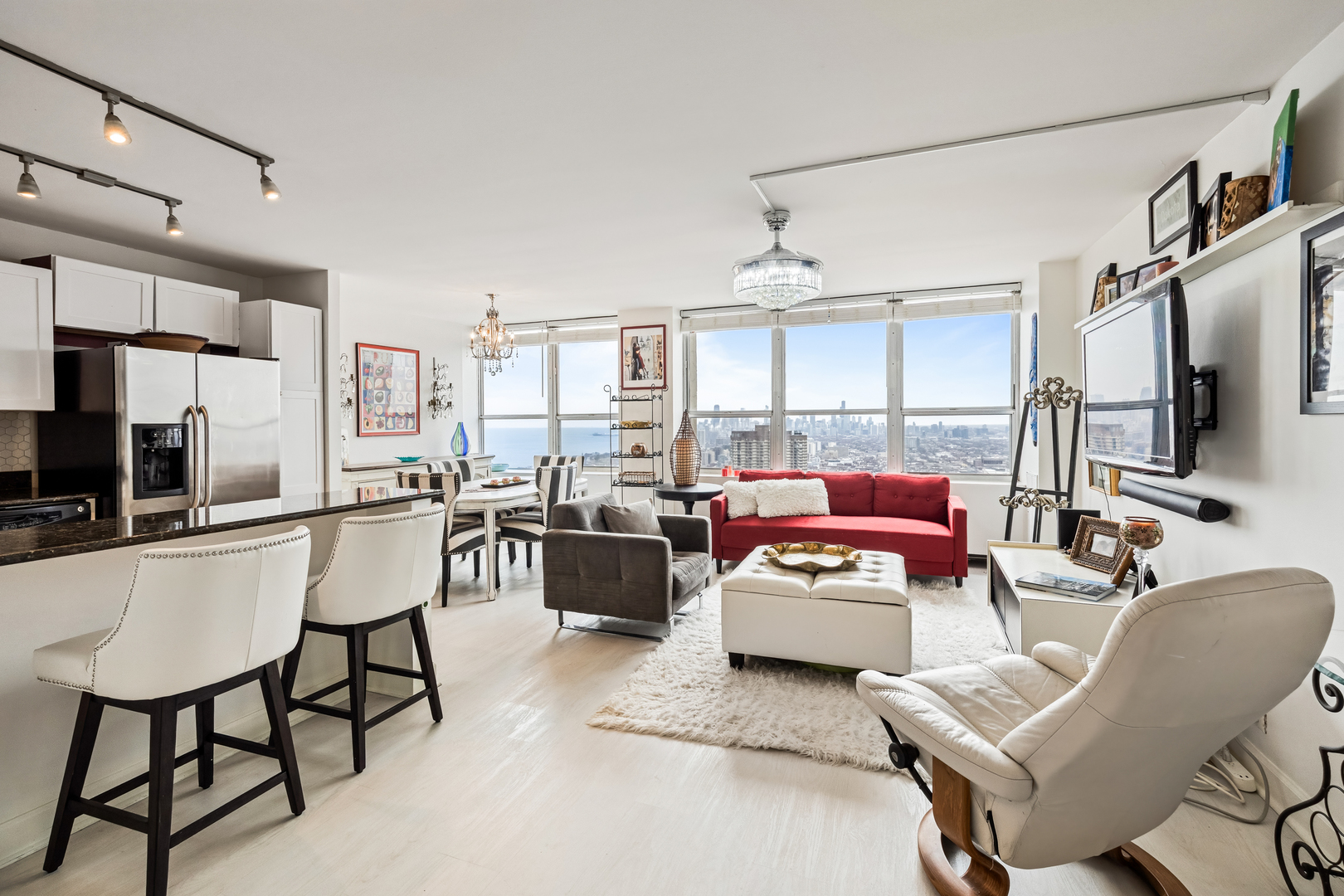 655 West Irving Park Road, Unit 5315 Chicago, IL 60613 - Photo 2 of 29 a living room with furniture and a flat screen tv