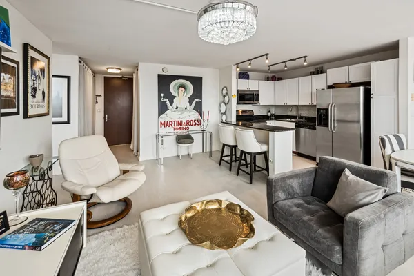 a living room with furniture and kitchen view
