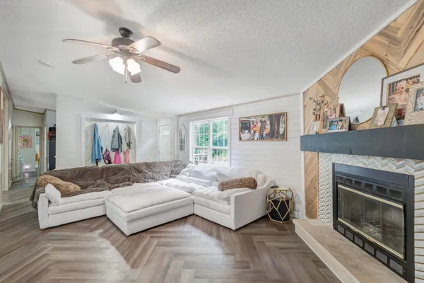 a living room with furniture and a fireplace
