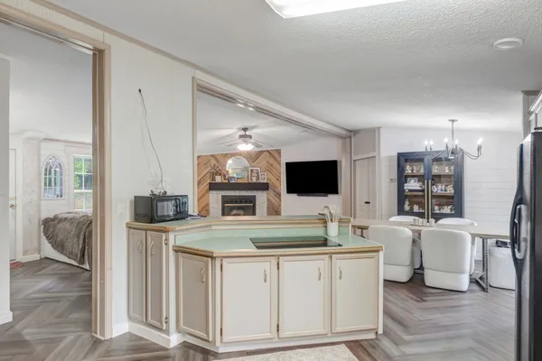 a kitchen with a sink and chairs