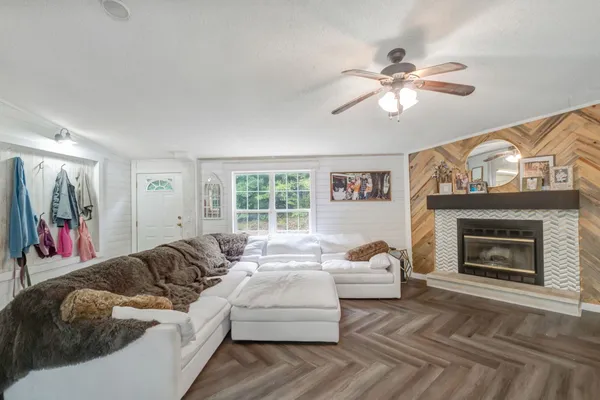 a living room with furniture and a fireplace